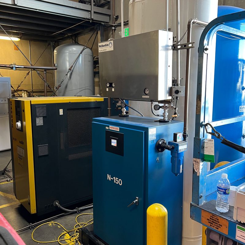 Kaeser air compressor, PSA nitrogen generator, McDantim Trumix gas blender, and buffer tank in a complete on-site MAP gas system